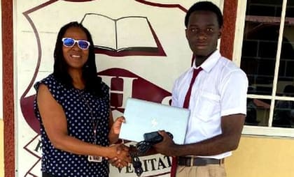 A Glenmuir student receiving a scholarship from a NY Chapter representative